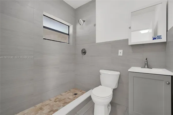 a bathroom with a sink a toilet and mirror