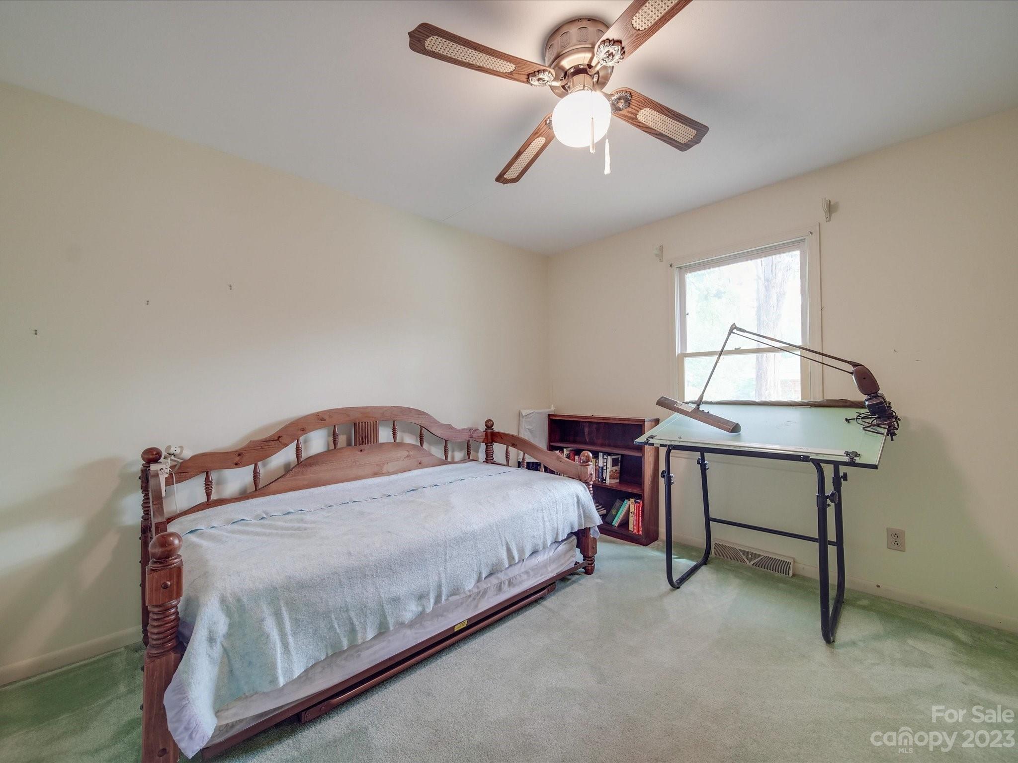 1296 Craig Avenue Lancaster, SC 29720 - Photo 28 of 31 a bedroom with a bed and a chandelier