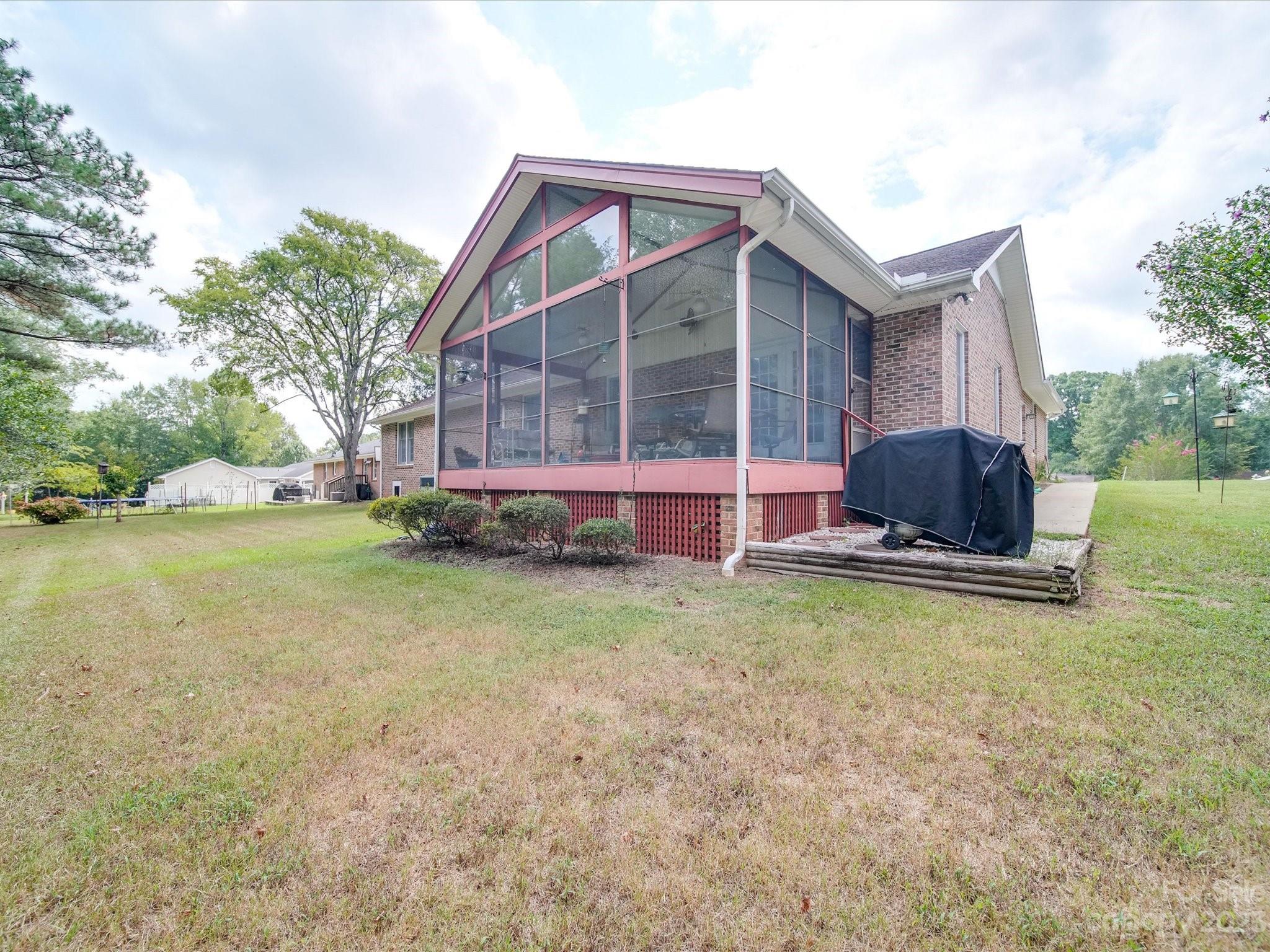 1296 Craig Avenue Lancaster, SC 29720 - Photo 4 of 31 a backyard of a house with wooden fence and a large tree