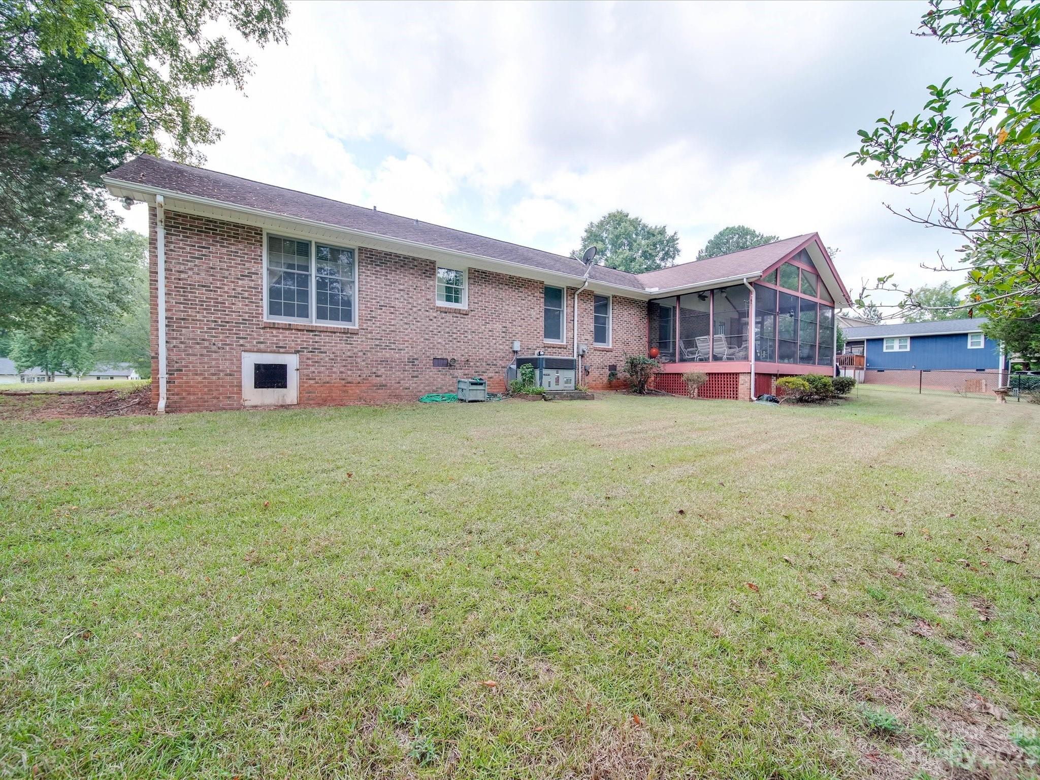 1296 Craig Avenue Lancaster, SC 29720 - Photo 5 of 31 a view of a house with a big yard and large trees