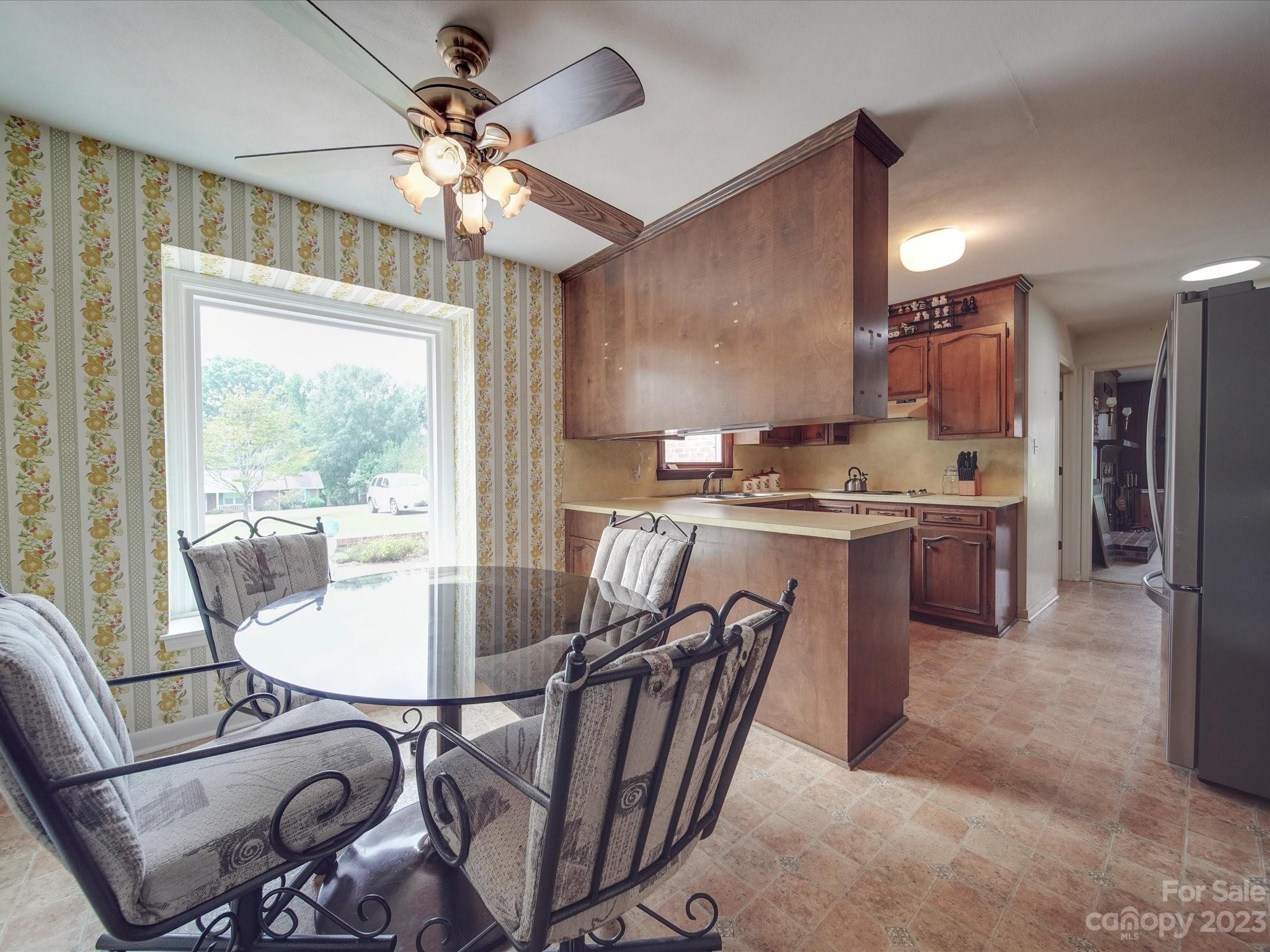 1296 Craig Avenue Lancaster, SC 29720 - Photo 8 of 31 a kitchen with a table chairs stove and refrigerator