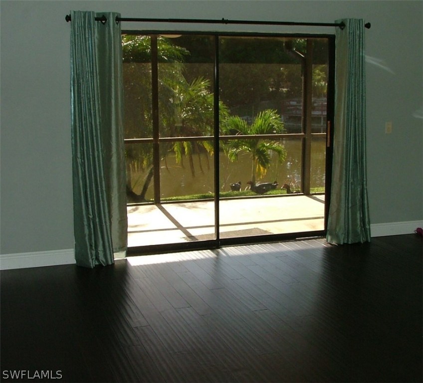17240 Trellis Road Fort Myers, FL 33967 - Photo 11 of 12 a view of a room with wooden floor and window