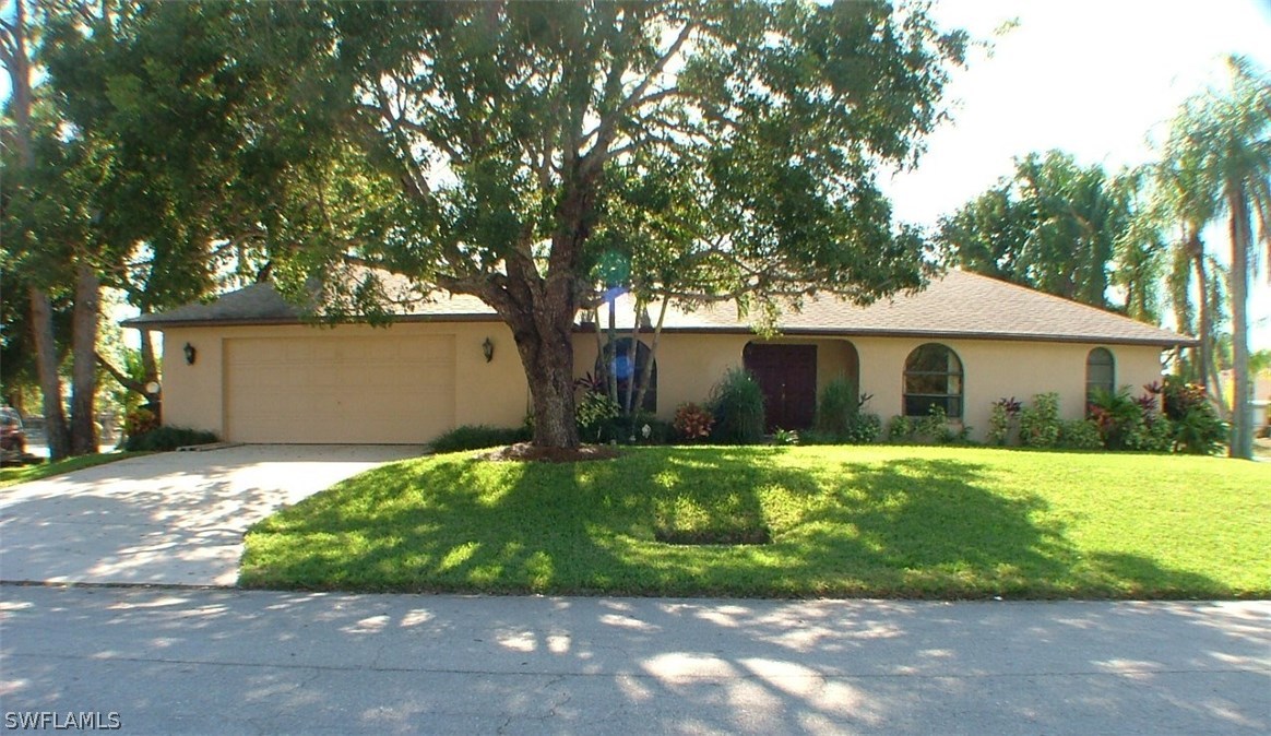 17240 Trellis Road Fort Myers, FL 33967 - Photo 2 of 12 a front view of house with yard and green space
