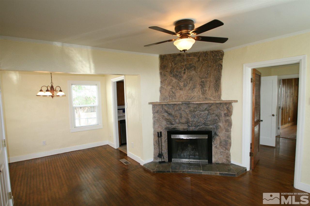 620 Thoma Street Reno, NV 89502 - Photo 4 of 13 a view of an empty room with wooden floor and a fireplace