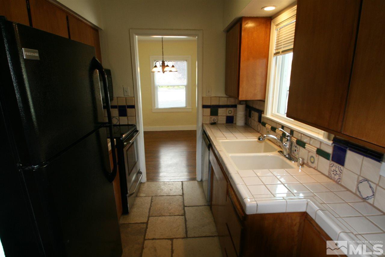 620 Thoma Street Reno, NV 89502 - Photo 5 of 13 a bathroom with a sink a toilet and a mirror