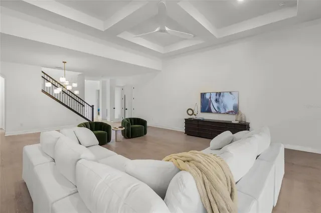 a spacious bedroom with a bed and a ceiling fan