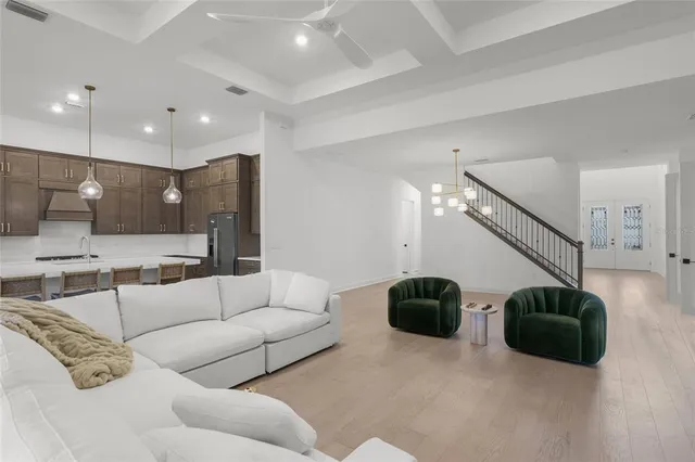 a bedroom with a bed a ceiling fan and a couch