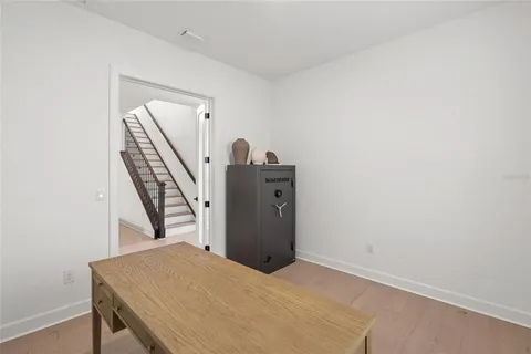 a spacious bedroom with a bed and a flat screen tv