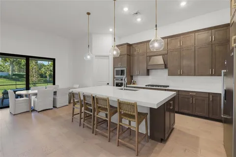 a large kitchen with a table and chairs