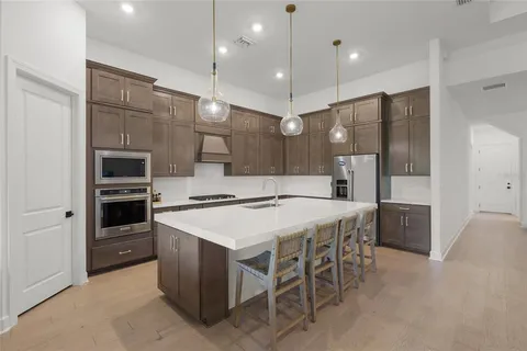a large kitchen with a table and chairs