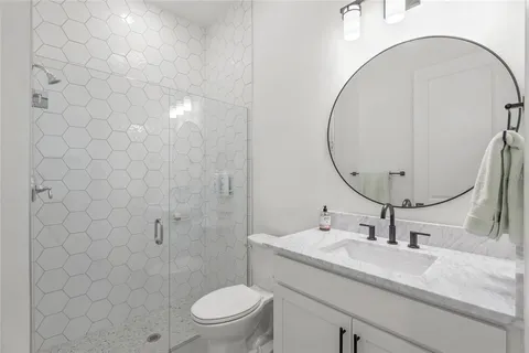 an empty room with large windows and a projector screen