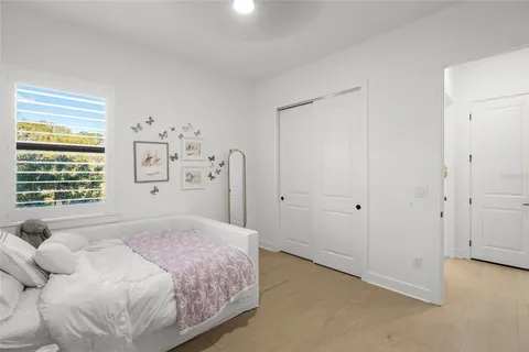 a bedroom with a bed and a ceiling fan