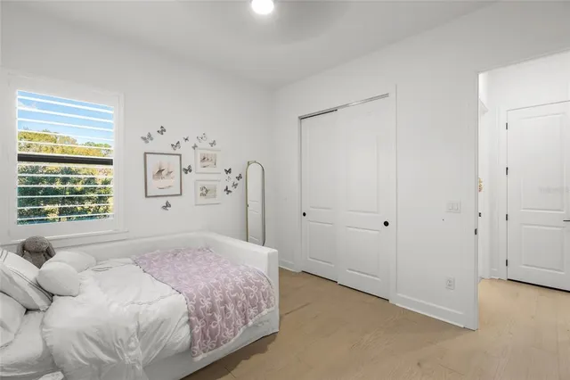 a bedroom with a bed and a ceiling fan
