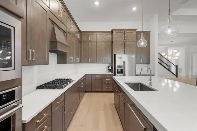 a kitchen with granite countertop a sink stove and cabinets