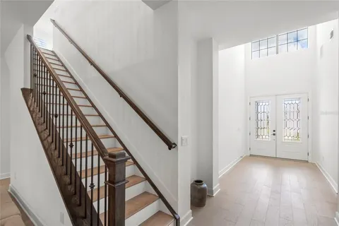 a bedroom with a bed and a chandelier fan
