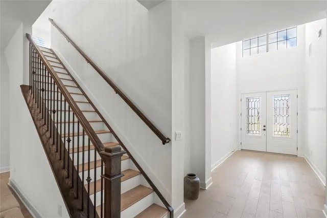 a bedroom with a bed and a chandelier fan