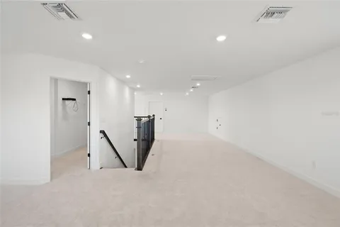 a living room with furniture and a large window with rug