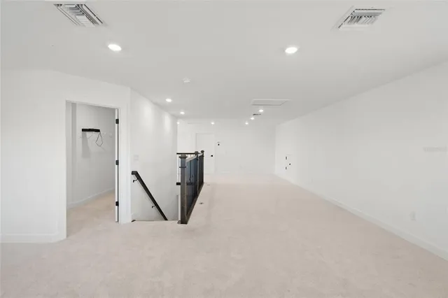 a living room with furniture and a large window with rug