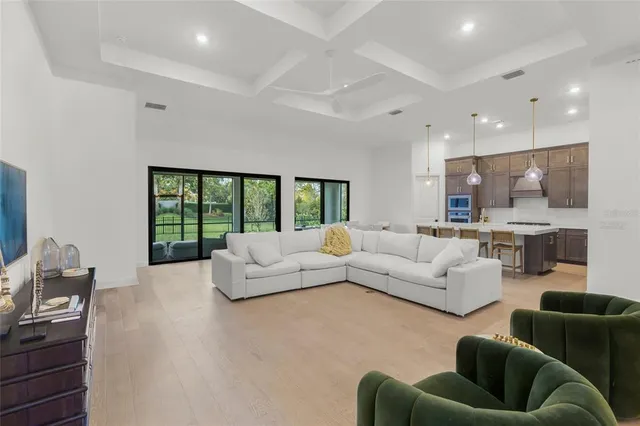 a living room with furniture and a ceiling fan