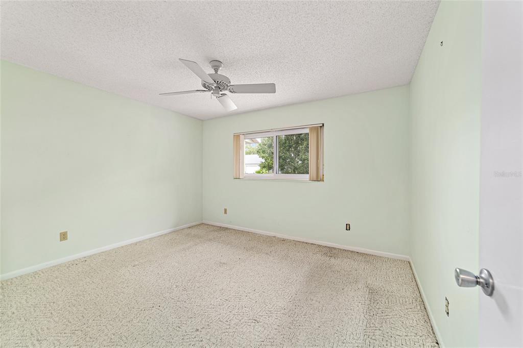 8678 Southwest 95 Street, Unit D Ocala, FL 34481 - Photo 23 of 36 an empty room with a window and a fan
