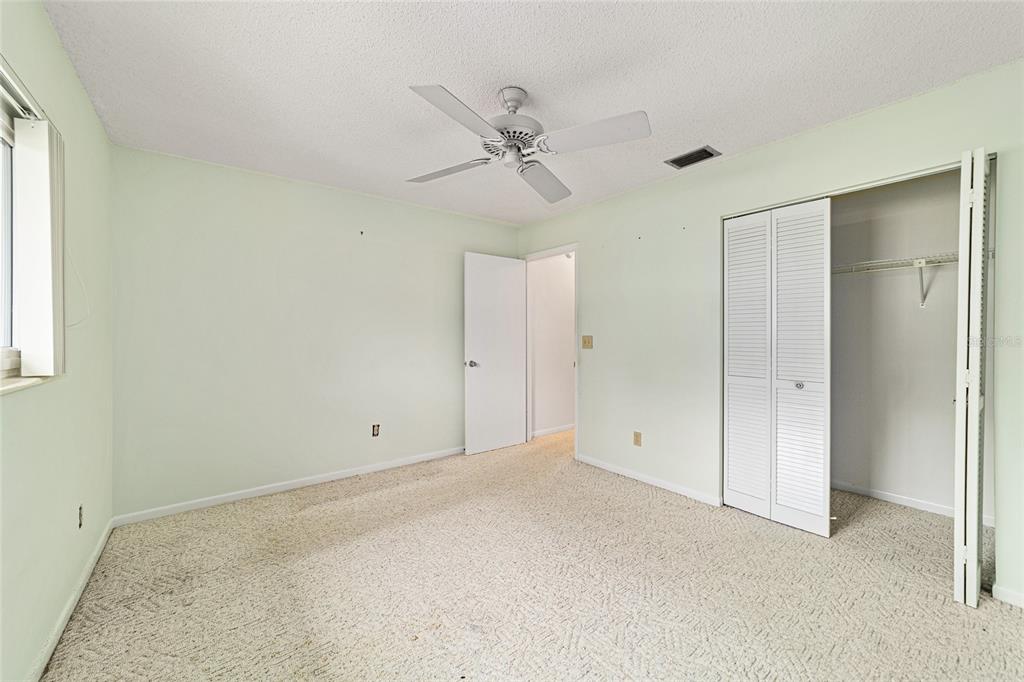 8678 Southwest 95 Street, Unit D Ocala, FL 34481 - Photo 24 of 36 an empty room with a ceiling fan and a window