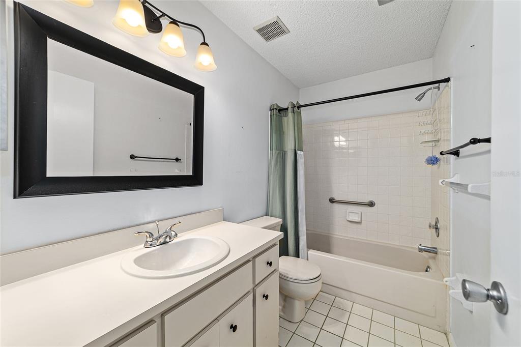 8678 Southwest 95 Street, Unit D Ocala, FL 34481 - Photo 25 of 36 a bathroom with a sink toilet vanity and shower