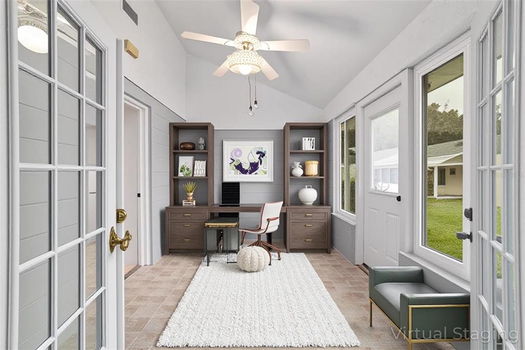 8678 Southwest 95 Street, Unit D Ocala, FL 34481 - Photo 26 of 36 a living room with furniture a chandelier and a table