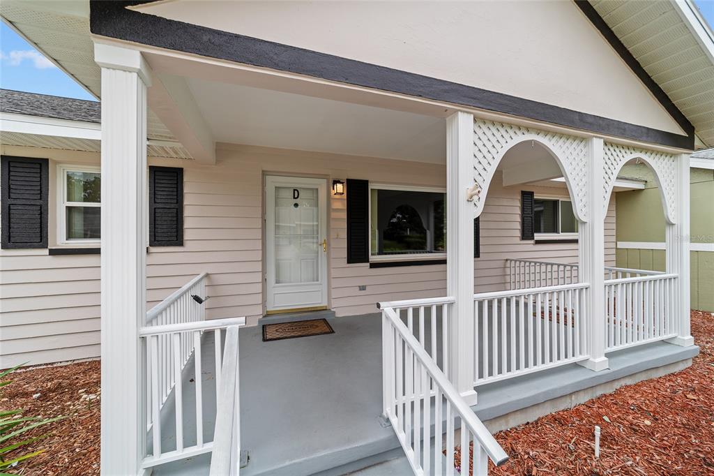 8678 Southwest 95 Street, Unit D Ocala, FL 34481 - Photo 3 of 36 a view of a house with wooden porch