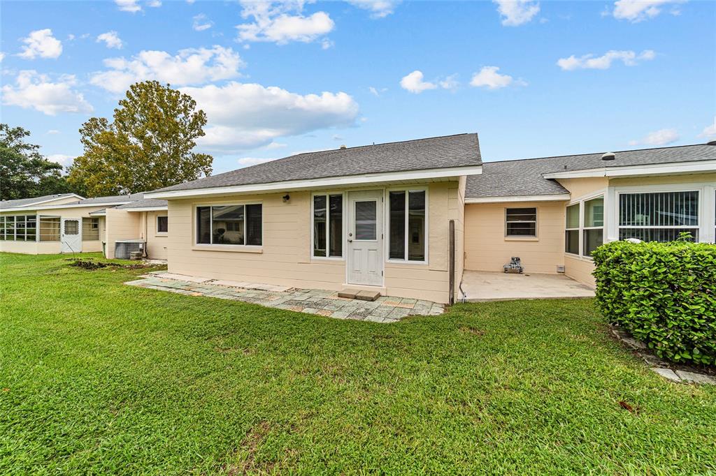 8678 Southwest 95 Street, Unit D Ocala, FL 34481 - Photo 35 of 36 a view of a house with a yard