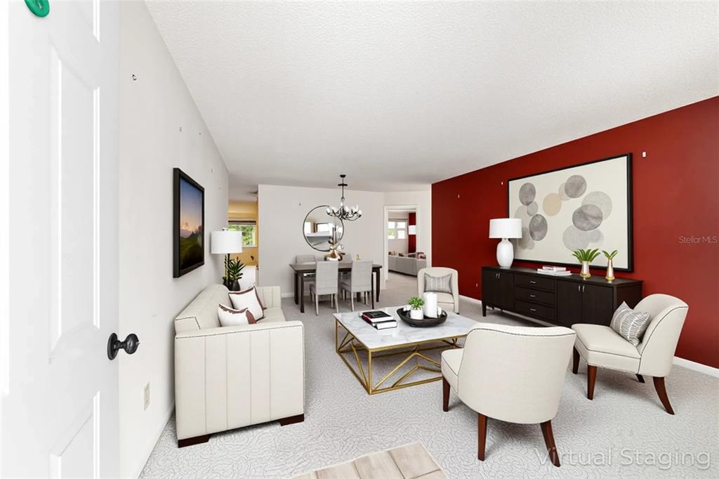 8678 Southwest 95 Street, Unit D Ocala, FL 34481 - Photo 5 of 36 a living room with furniture a flat screen tv and wall paintings