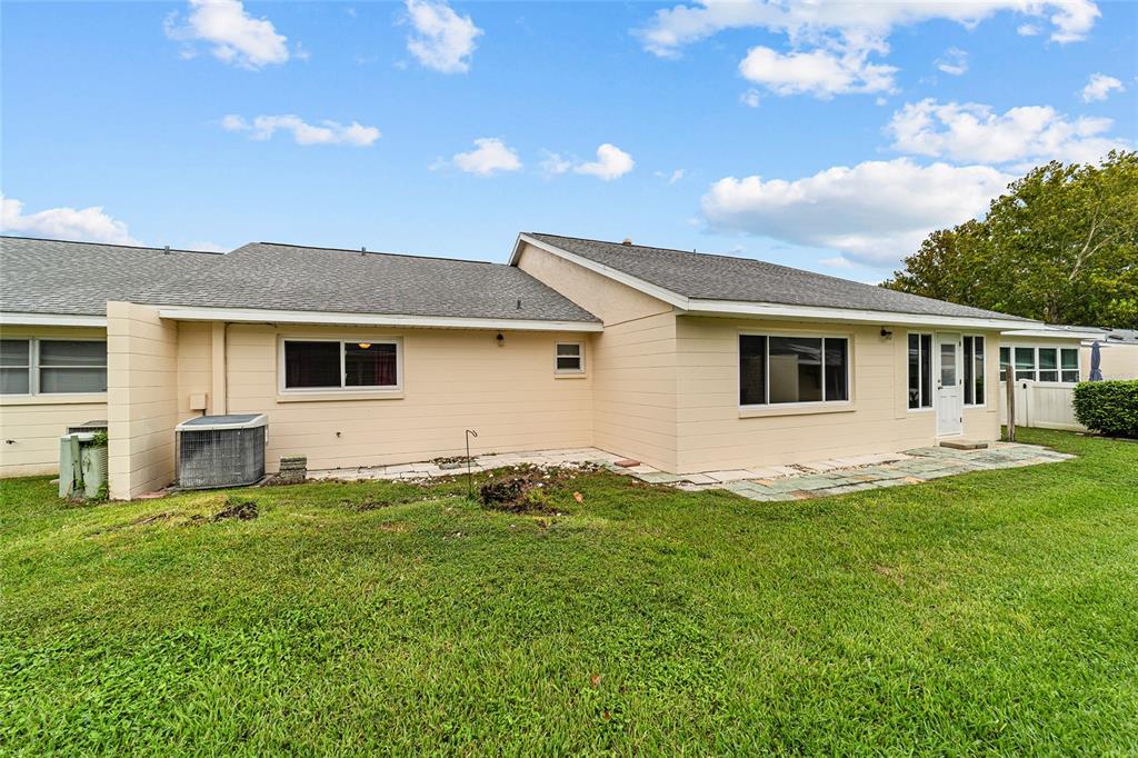 8678 Southwest 95 Street, Unit D Ocala, FL 34481 - Photo 9 of 36 a view of a house with a yard