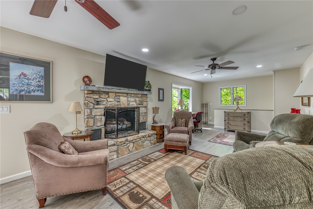 174 Spruce Pine Road Newland, NC 28657 - Photo 15 of 50 a living room with furniture ceiling fan and a fireplace