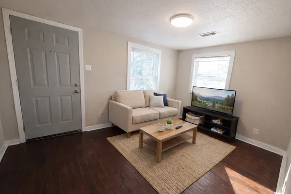 a living room with furniture and a flat screen tv