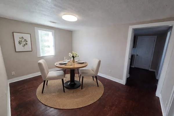 a dining room with furniture and wooden floor