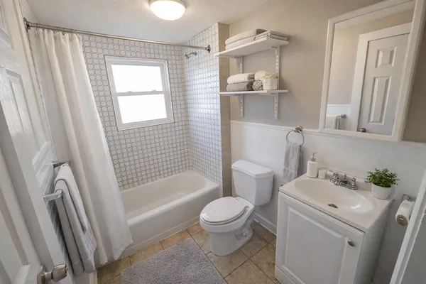 a bathroom with a sink toilet and shower