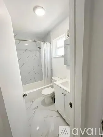 a bathroom with a granite countertop sink a toilet and shower