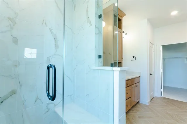 a bathroom with a granite countertop shower sink and mirror