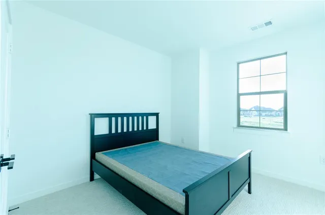 a room with a bed and a window