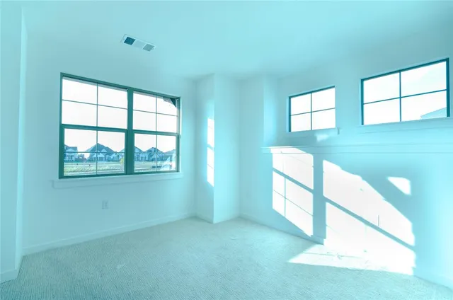 a view of an empty room with windows