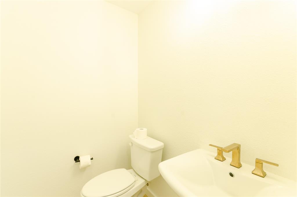 1248 Armstrong The Colony, TX 75056 - Photo 21 of 25 a bathroom with a toilet and a sink