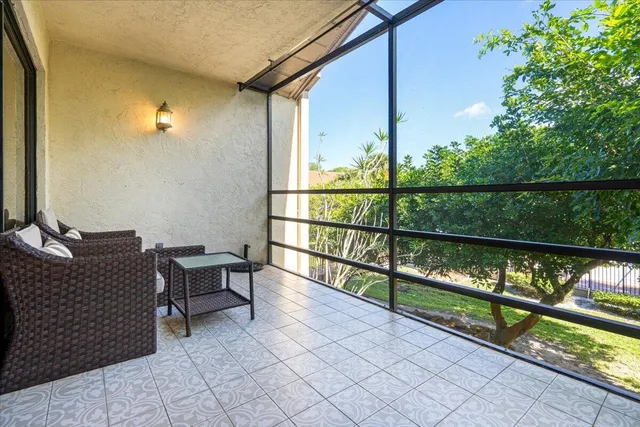 a view of a chairs and table in the balcony