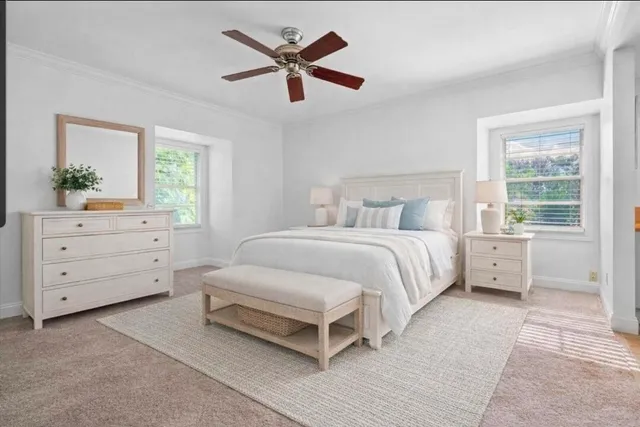 a bedroom with a large bed and a window