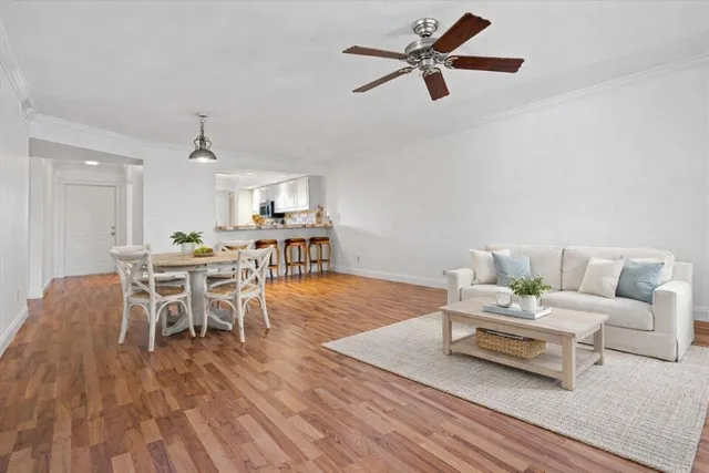 a living room with furniture a wooden floor and a table