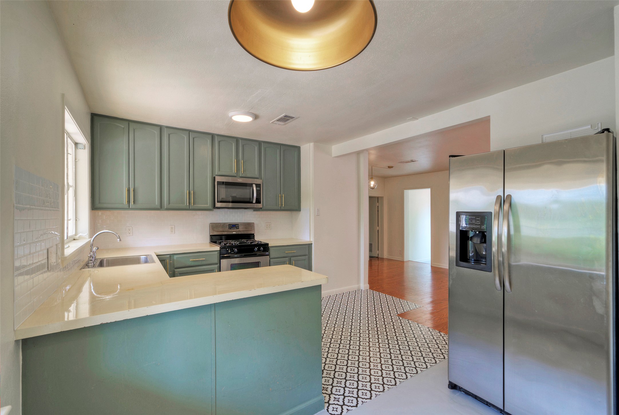 1803 Pearl Street Austin, TX 78701 - Photo 5 of 33 a kitchen with a refrigerator a sink and a cabinets