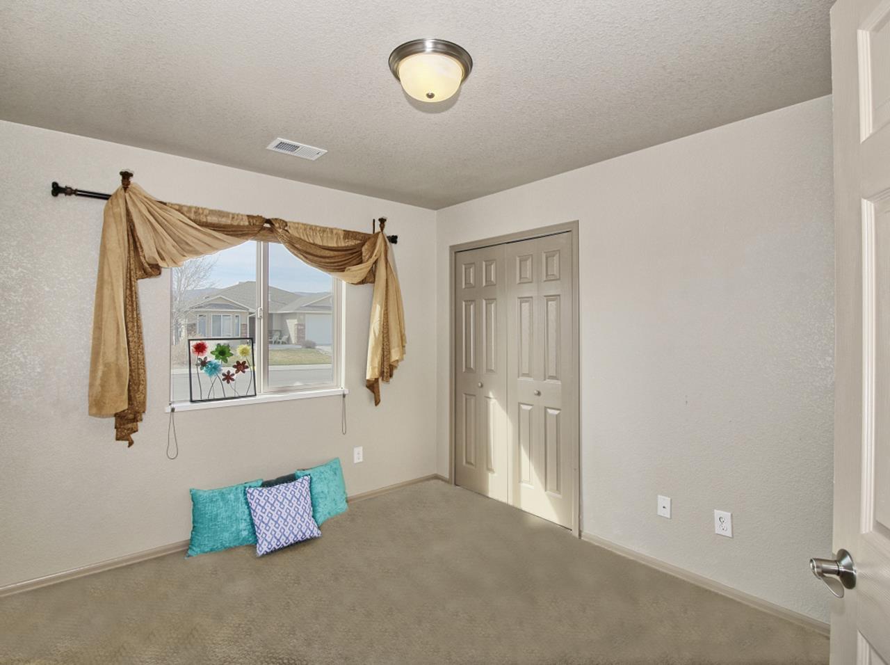 199 Red Rocks Street Fruita, CO 81521 - Photo 15 of 25 a view of a closet area with furniture and a window