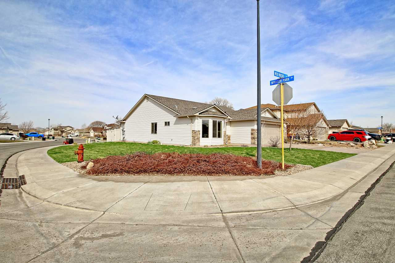 199 Red Rocks Street Fruita, CO 81521 - Photo 21 of 25 a front view of a house with a yard and potted plants