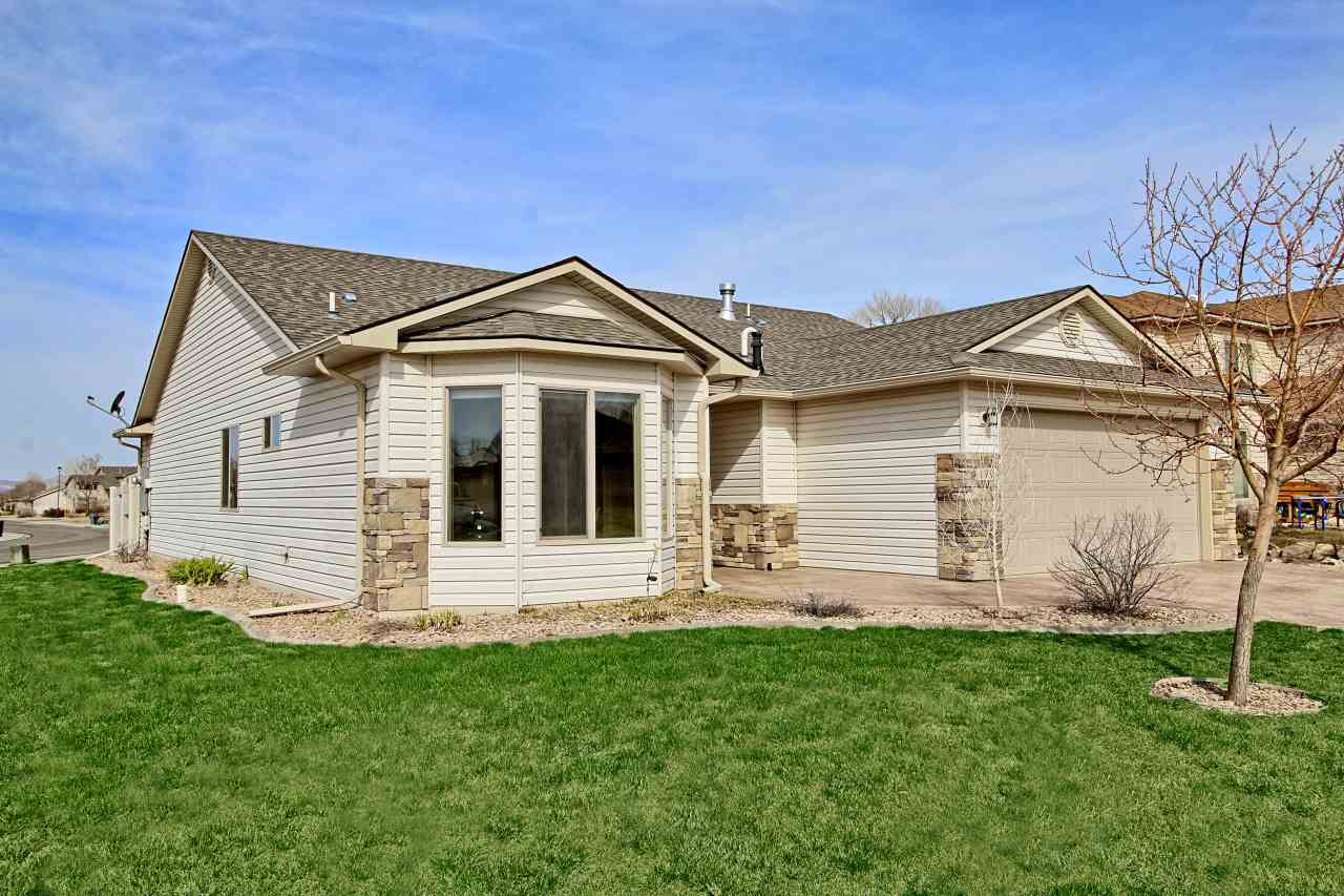 199 Red Rocks Street Fruita, CO 81521 - Photo 22 of 25 a front view of a house with a yard