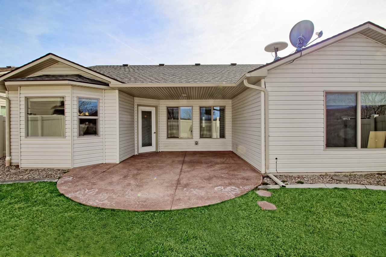 199 Red Rocks Street Fruita, CO 81521 - Photo 23 of 25 a view of a house with a backyard and porch