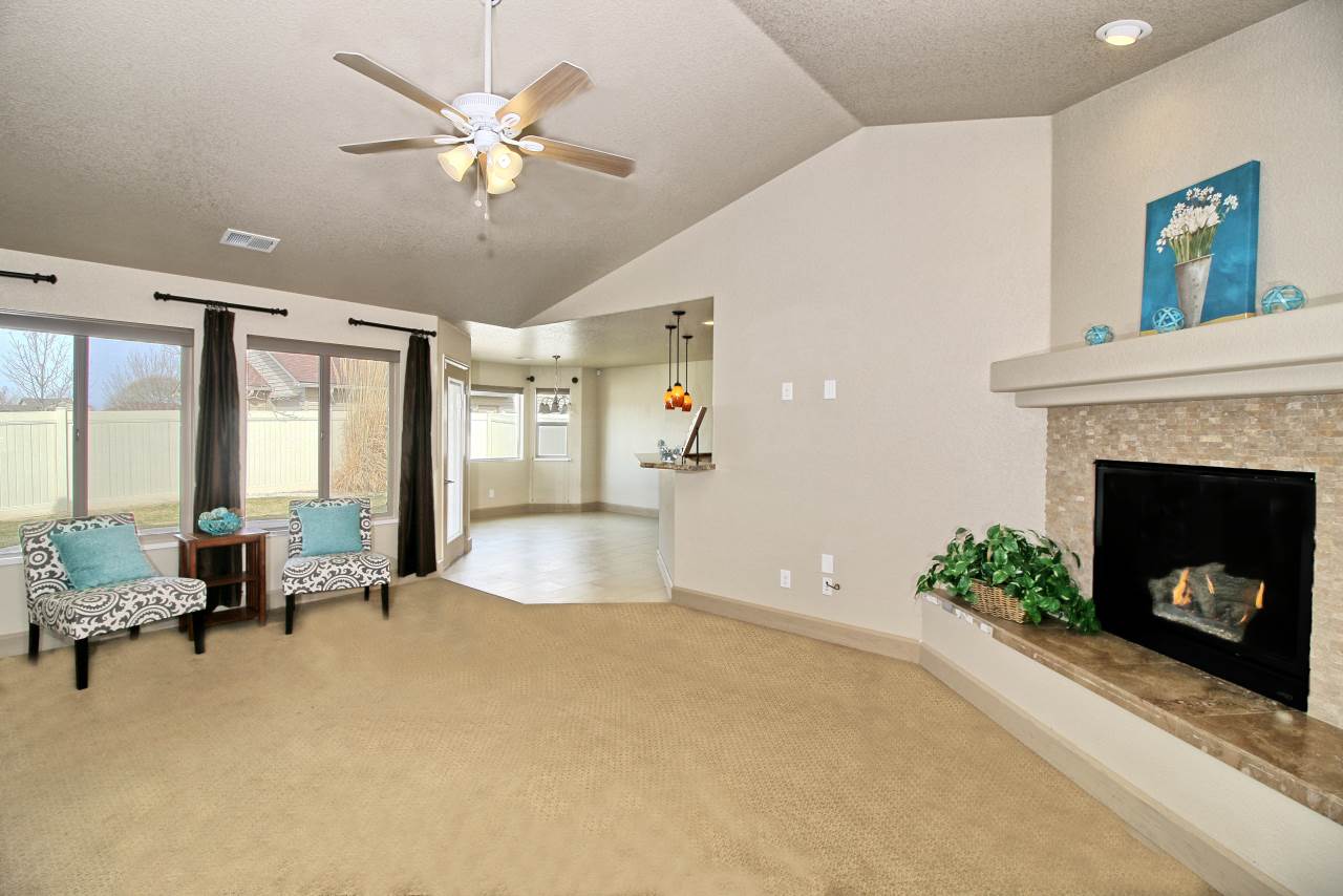 199 Red Rocks Street Fruita, CO 81521 - Photo 4 of 25 a living room with furniture and a fireplace