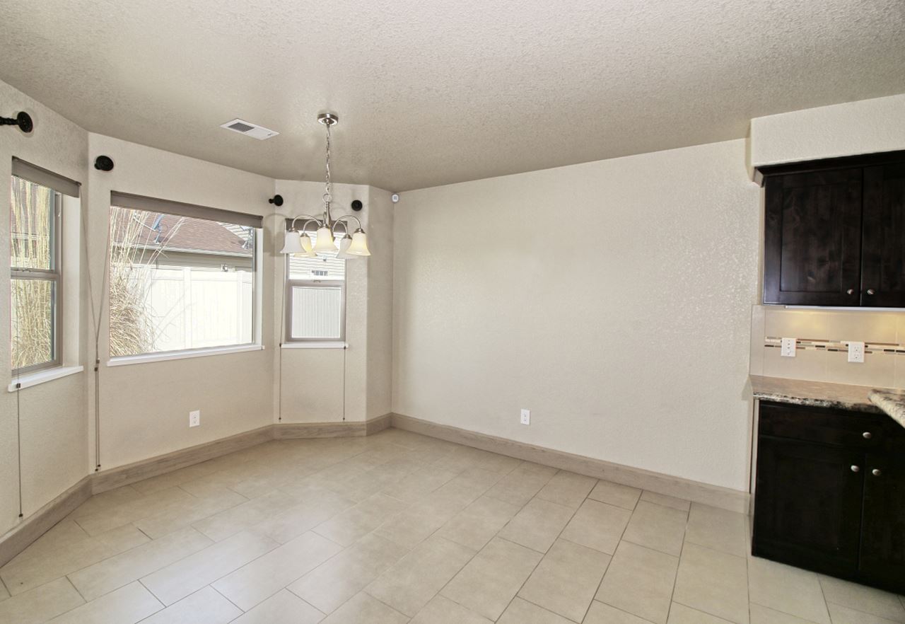 199 Red Rocks Street Fruita, CO 81521 - Photo 6 of 25 a view of an empty room with a kitchen